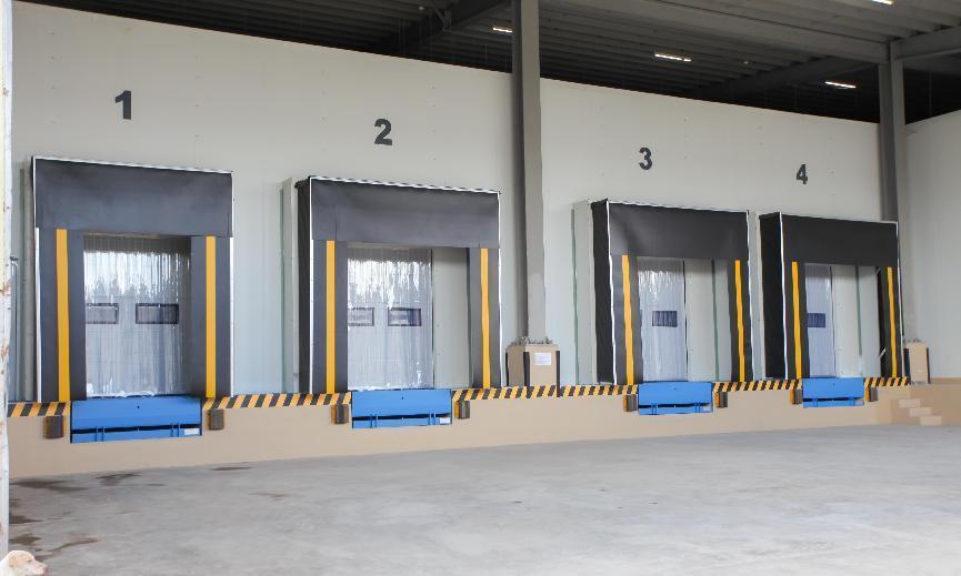 Cold chain logistics warehouse loading docks with dock levelers and insulated curtains for freezer room distribution